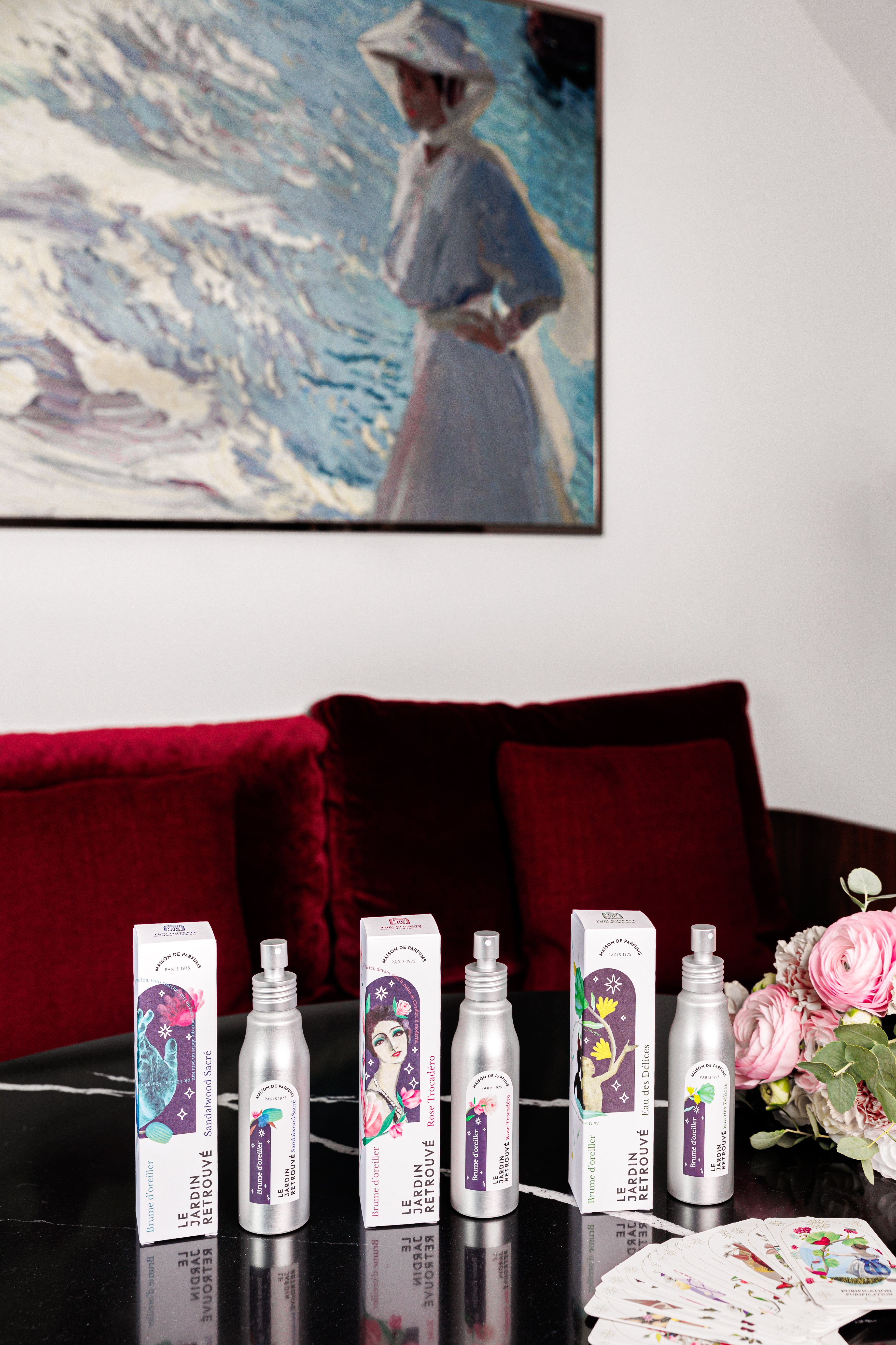 Les Brumes du Jardin Retrouvé ( Sandalwood Sacré, Rose Trocadéro, Eau des Délices) et les cartes Oracle du Jardin Retrouvé , sur une table de l'hotel Maison Colbert Paris