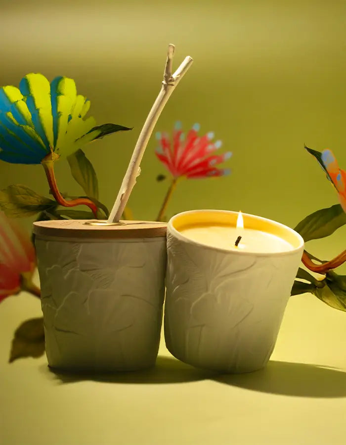 "Flat-lay of Le Jardin Retrouvé wellbeing products including candles and diffusers, styled with delicate flowers and natural elements on a soft background, evoking tranquility and self-care."